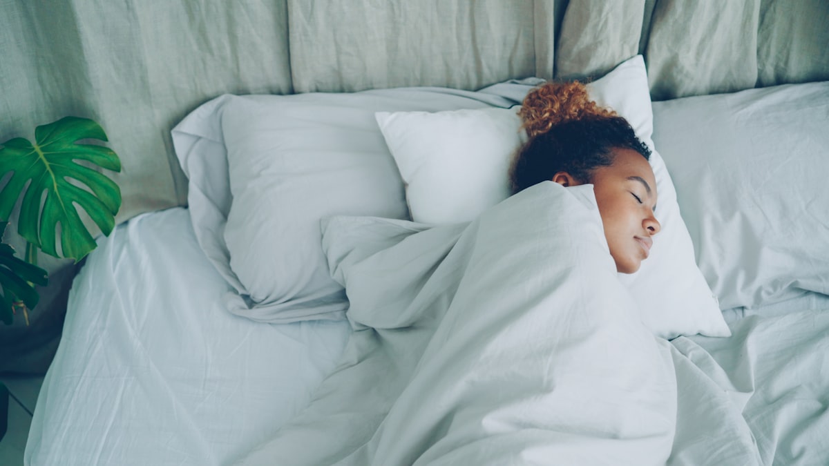 Man sleeping peacefully in a well-organized bedroom